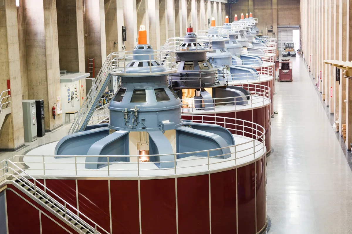 Row of large hydroelectric generators along a long power station hall